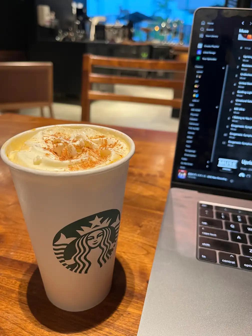 Zayn drinking a coffee with his laptop pretending to work while at Starbucks